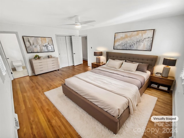 bedroom with connected bathroom, ceiling fan, a closet, and hardwood / wood-style floors