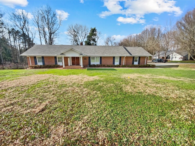 ranch-style house featuring a front lawn