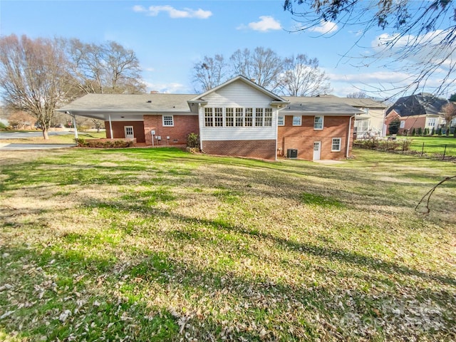 rear view of house featuring a yard