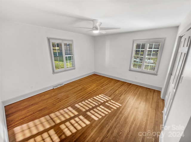 spare room with wood-type flooring and ceiling fan