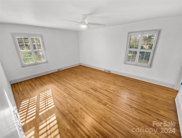 spare room featuring ceiling fan and light hardwood / wood-style floors