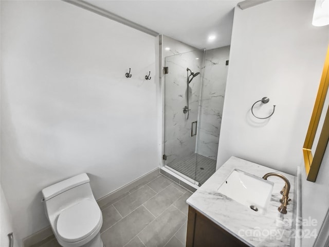 bathroom with tile patterned flooring, vanity, toilet, and a shower with shower door