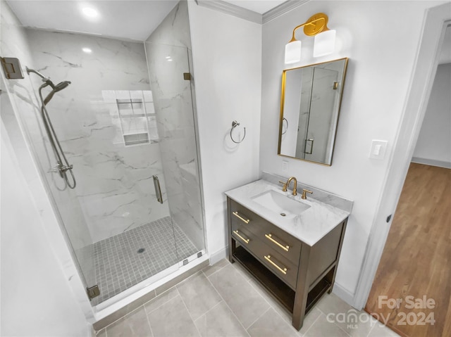 bathroom featuring tile patterned flooring, vanity, and a shower with shower door