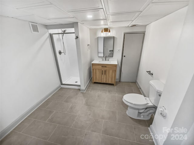 bathroom with vanity, toilet, and a shower with door