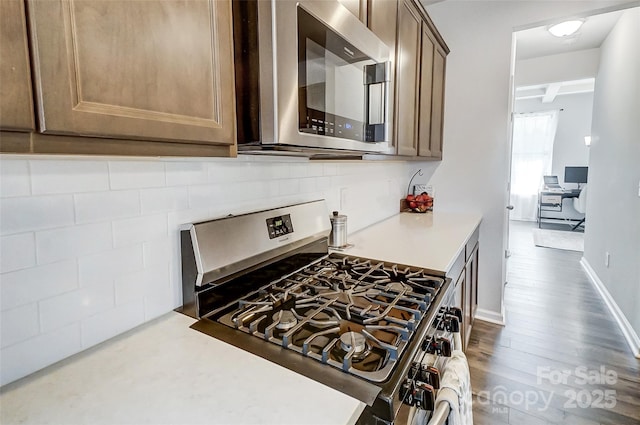 kitchen featuring appliances with stainless steel finishes and beam ceiling