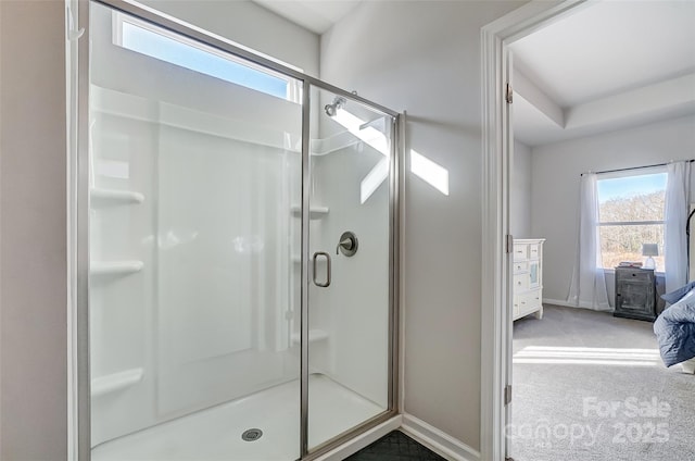 bathroom featuring a shower with shower door