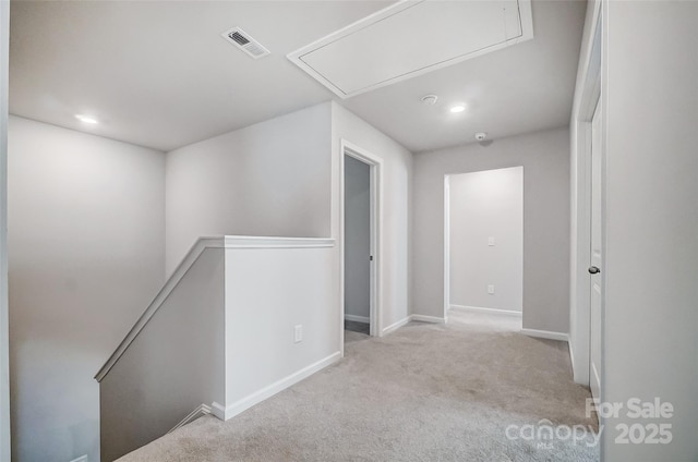 hallway with light colored carpet