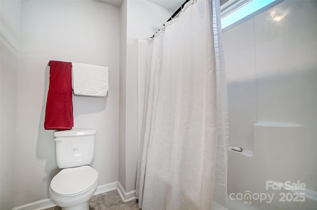 bathroom with walk in shower and toilet