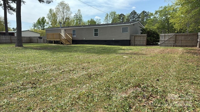 back of house featuring a yard, a fenced backyard, and crawl space