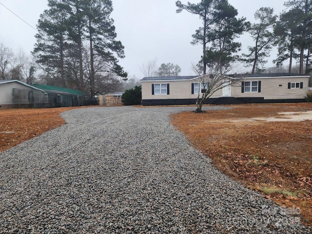 manufactured / mobile home featuring crawl space and driveway