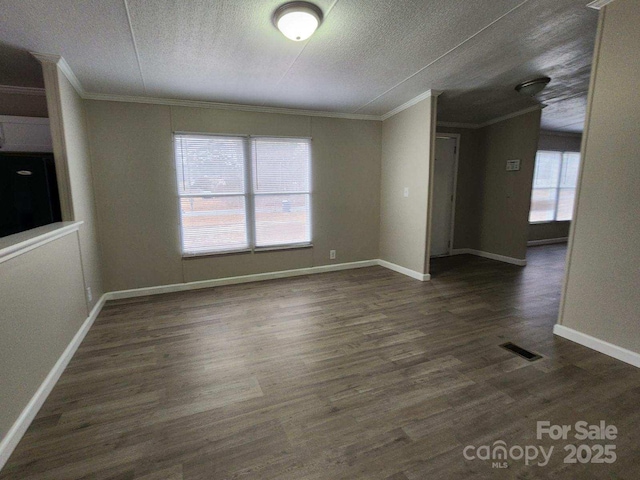 interior space with crown molding, wood finished floors, visible vents, and a textured ceiling