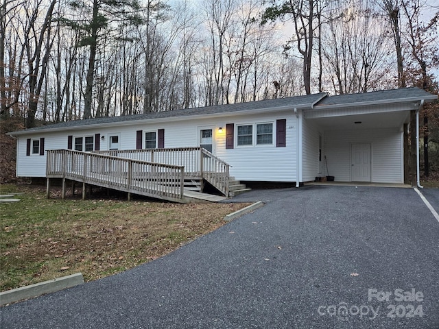 view of front of house with a deck and a carport