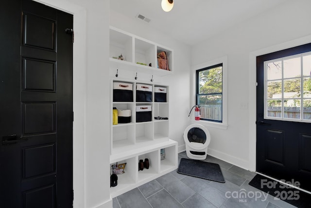 mudroom featuring dark tile patterned flooring