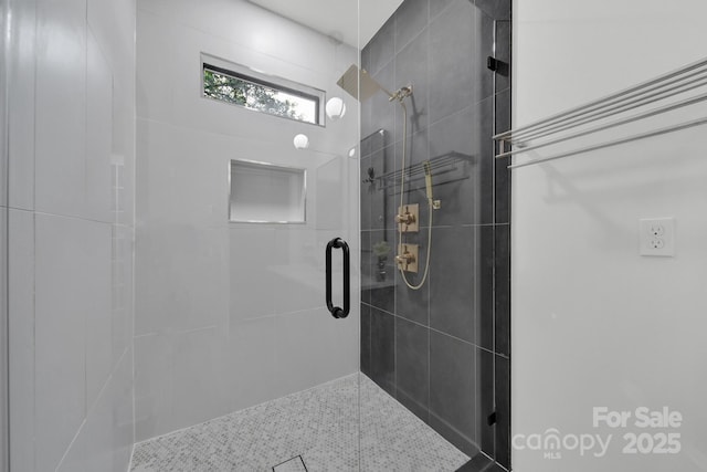 bathroom with a shower with door