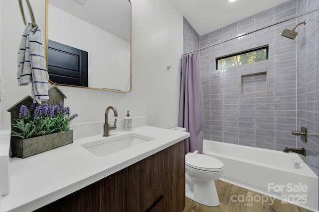 full bathroom with hardwood / wood-style floors, vanity, toilet, and shower / bath combo with shower curtain