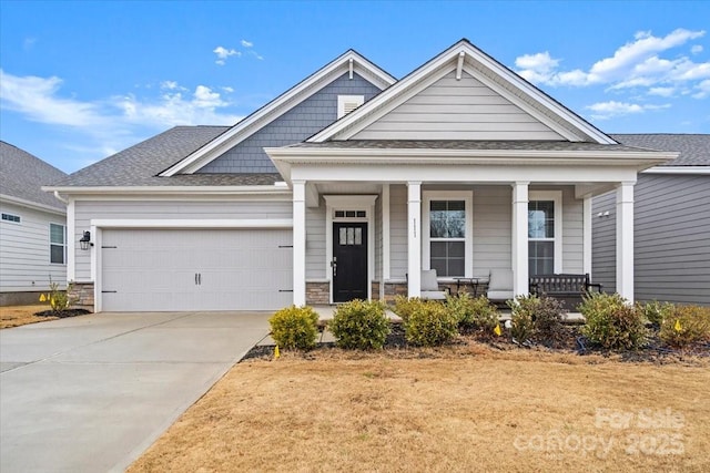 craftsman inspired home with a porch and a garage