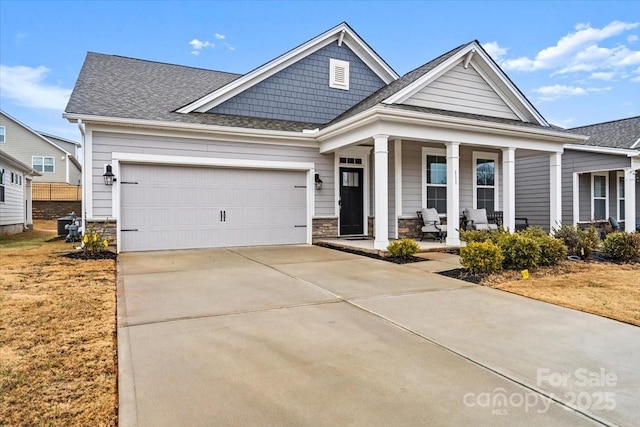 view of front of property featuring covered porch and a garage