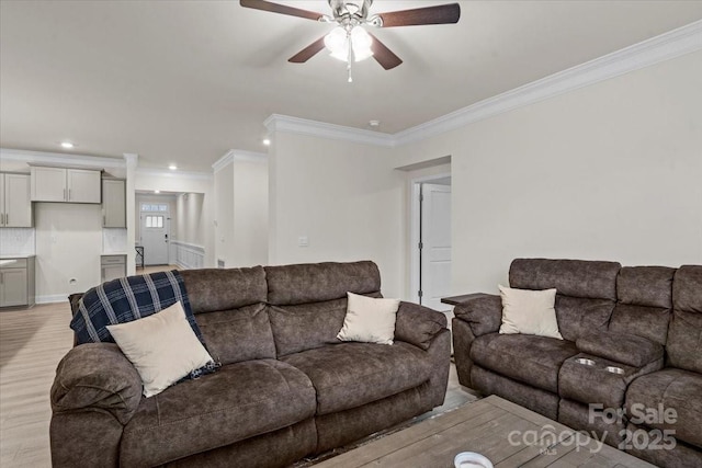 living room with ceiling fan, light hardwood / wood-style floors, and ornamental molding