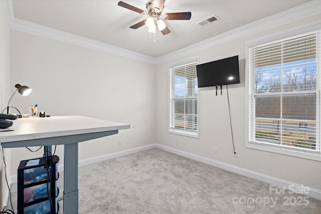 unfurnished office with light colored carpet, ceiling fan, and ornamental molding