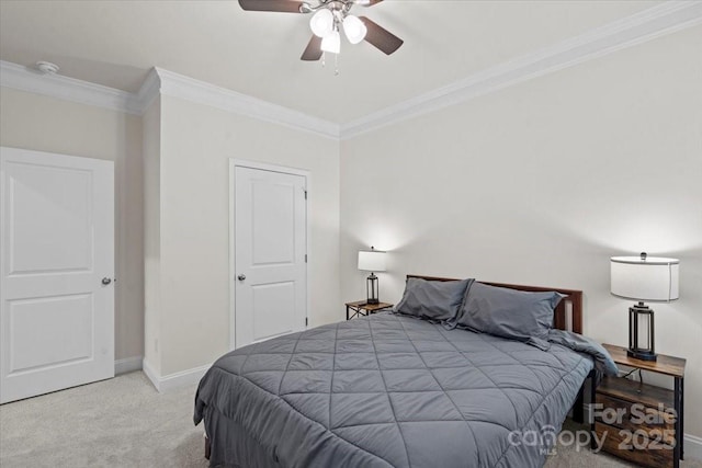 carpeted bedroom featuring ceiling fan and ornamental molding