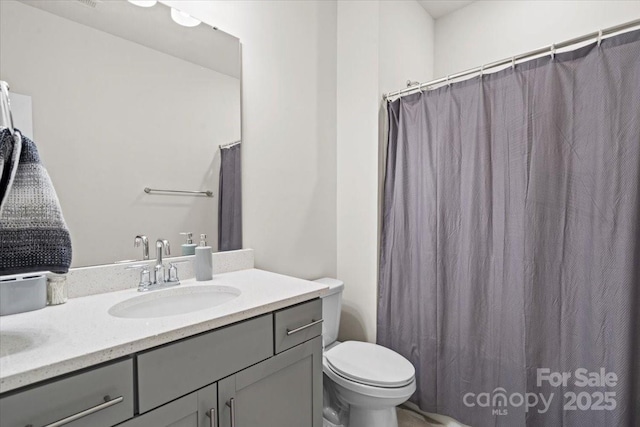 bathroom featuring vanity and toilet