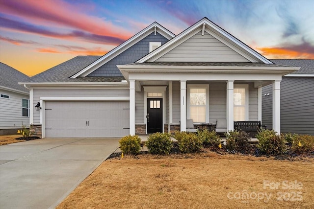 craftsman inspired home with a porch and a garage