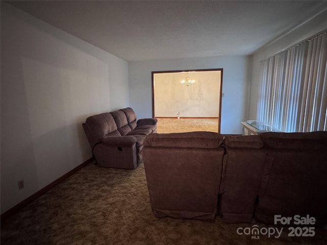 carpeted living room with a chandelier