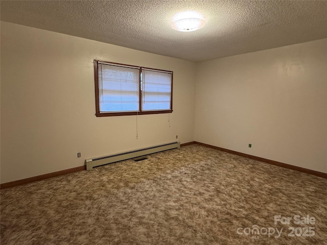 spare room featuring baseboard heating, carpet flooring, and a textured ceiling