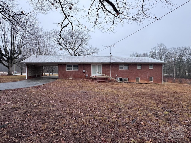 back of property with a carport