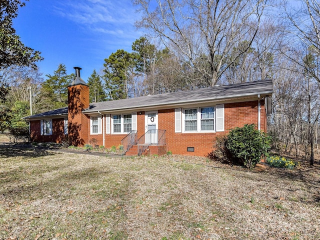 single story home featuring crawl space, a chimney, a front lawn, and brick siding