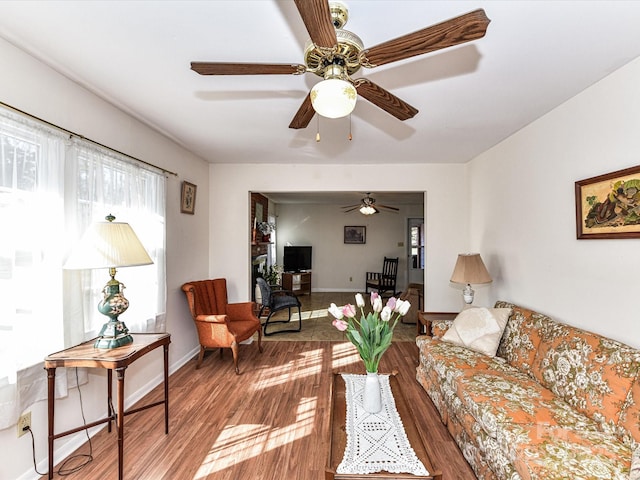 living room with baseboards and wood finished floors