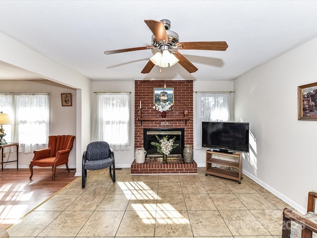 living room with a healthy amount of sunlight, a fireplace, a textured ceiling, and light tile patterned floors