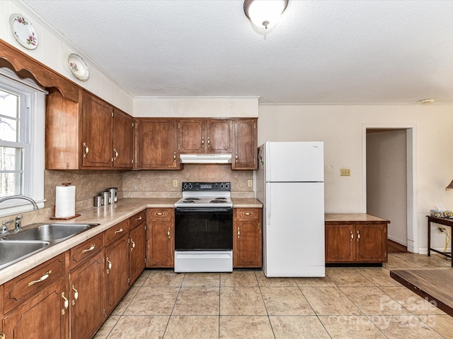 kitchen with freestanding refrigerator, under cabinet range hood, light countertops, and electric range