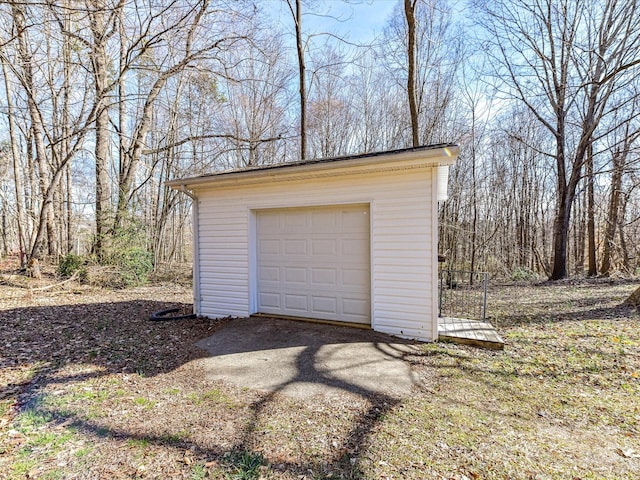 detached garage with dirt driveway