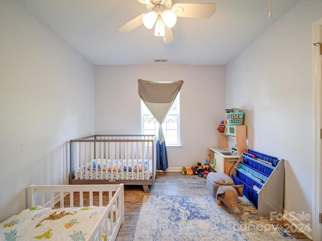 bedroom featuring hardwood / wood-style floors and ceiling fan