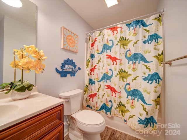 full bathroom featuring hardwood / wood-style floors, vanity, toilet, and shower / bathtub combination with curtain