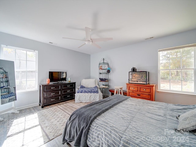 bedroom with ceiling fan and light hardwood / wood-style flooring