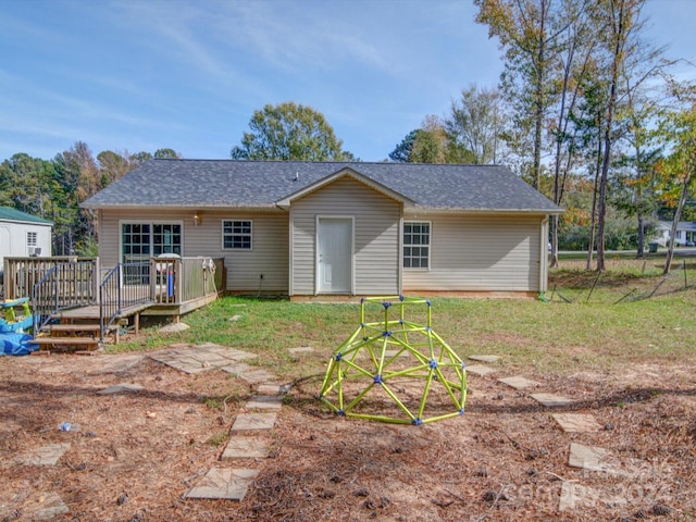 back of house featuring a deck and a yard