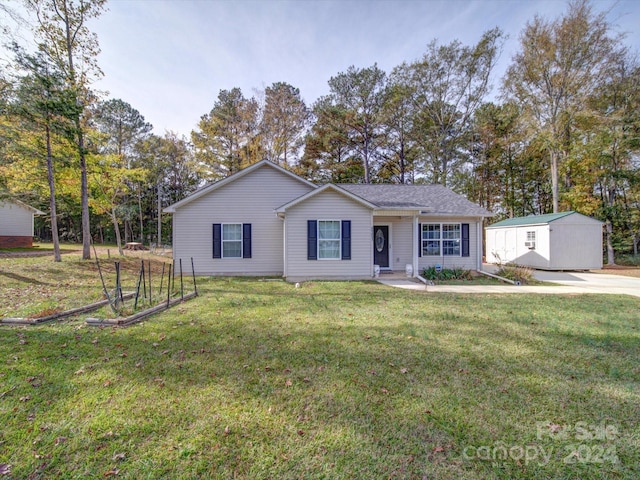 ranch-style house featuring a storage shed and a front yard