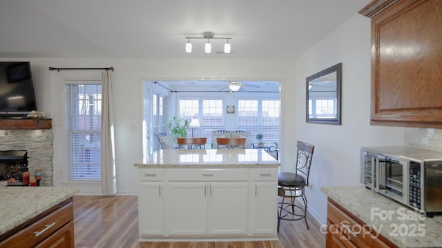 kitchen featuring light hardwood / wood-style flooring, white cabinets, and a healthy amount of sunlight