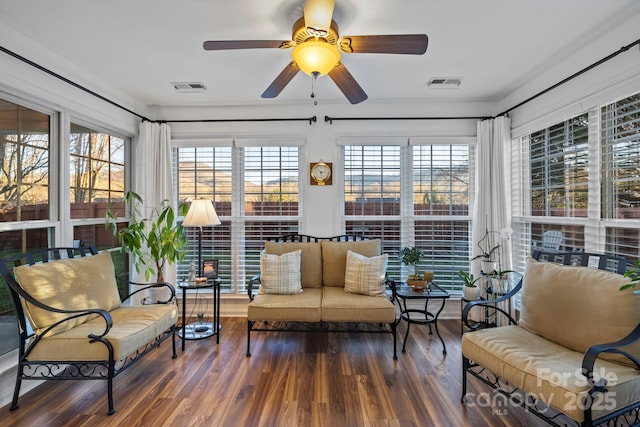 sunroom / solarium featuring plenty of natural light and ceiling fan