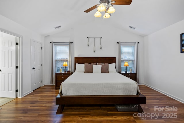 bedroom with ceiling fan, dark hardwood / wood-style floors, and multiple windows