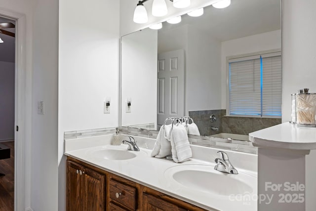 bathroom featuring a tub to relax in and vanity