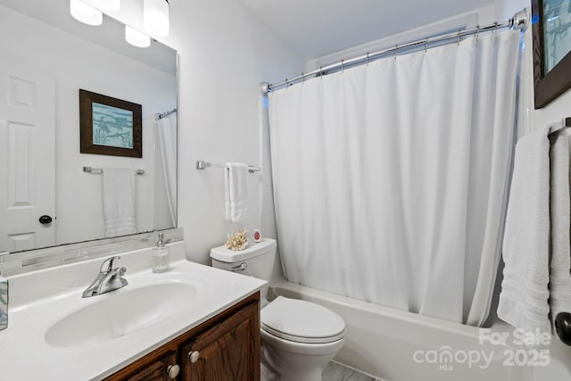 full bathroom with shower / bath combination with curtain, vanity, and toilet