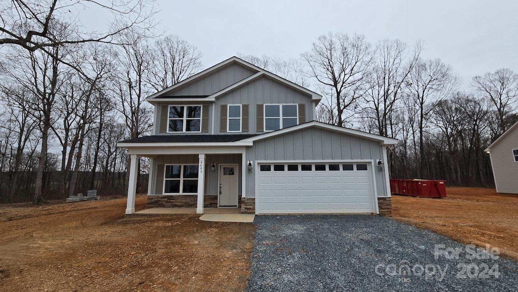 view of front of property with a porch and a garage