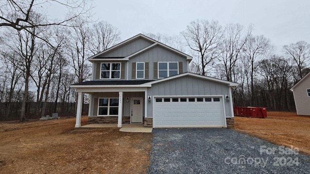 view of front of property with a porch and a garage