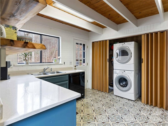 clothes washing area featuring wooden ceiling, stacked washer / drying machine, and sink