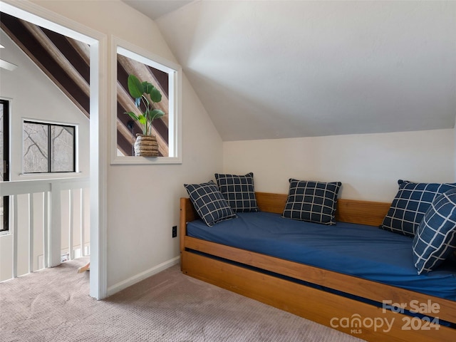 bedroom featuring carpet and lofted ceiling