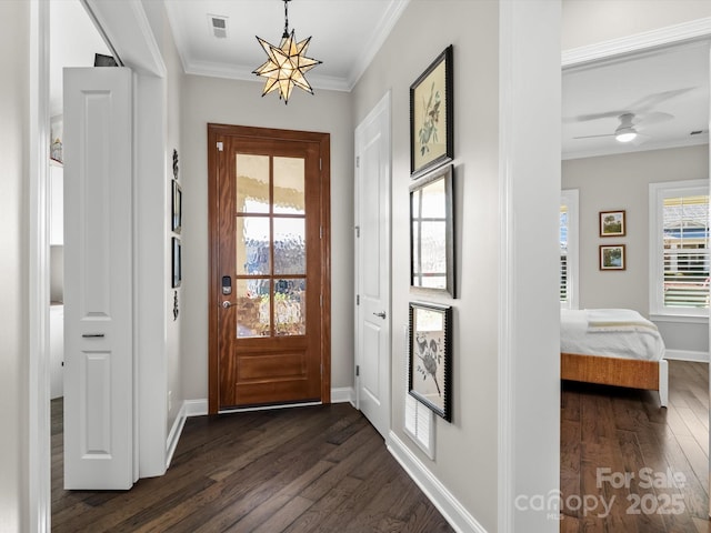 entryway with ceiling fan with notable chandelier, dark wood-type flooring, a wealth of natural light, and crown molding