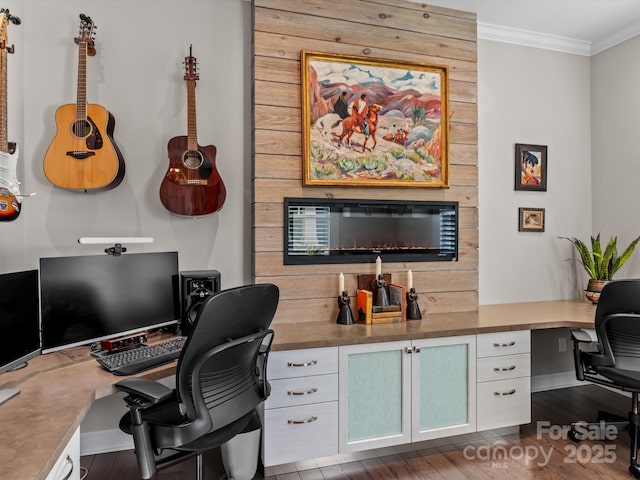 home office with built in desk, dark hardwood / wood-style floors, and crown molding